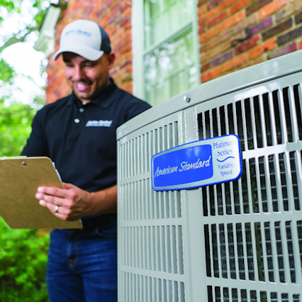 American Standard technician with air conditioner